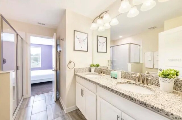 bathroom featuring vanity, tile patterned floors, and walk in shower