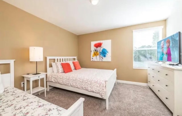 bedroom featuring light colored carpet