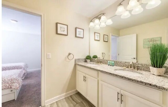 bathroom with vanity and a notable chandelier