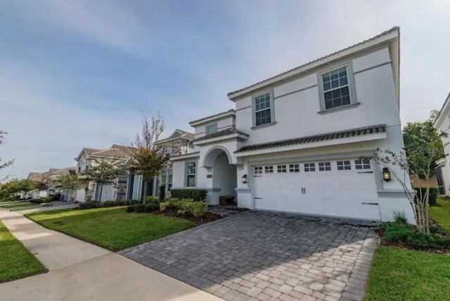 view of front of house featuring a garage and a front lawn