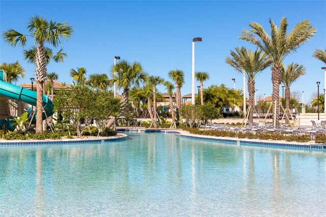 view of swimming pool with a water slide