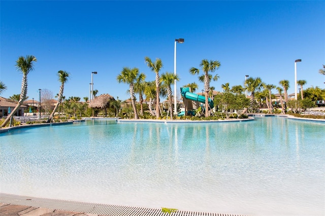 view of swimming pool with a water slide