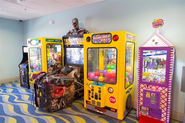 playroom with a paneled ceiling and carpet