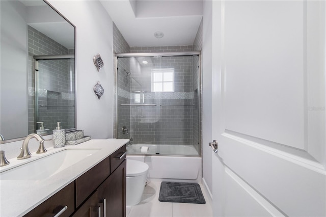 full bathroom featuring shower / bath combination with glass door, tile patterned flooring, toilet, and vanity