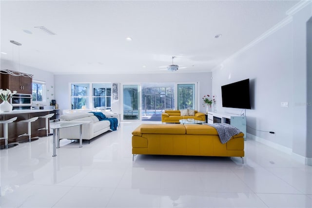 tiled living room with crown molding and ceiling fan