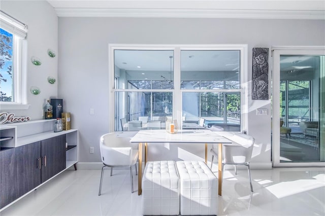 tiled dining area with plenty of natural light and ornamental molding