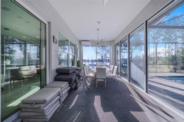 sunroom / solarium with an inviting chandelier and an AC wall unit