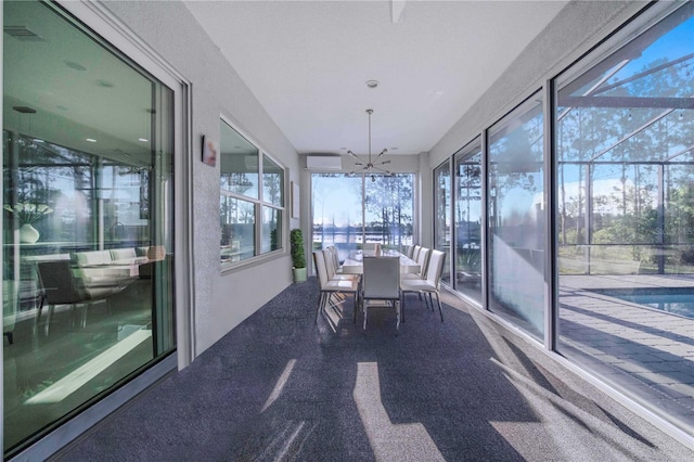 unfurnished sunroom with plenty of natural light and a chandelier