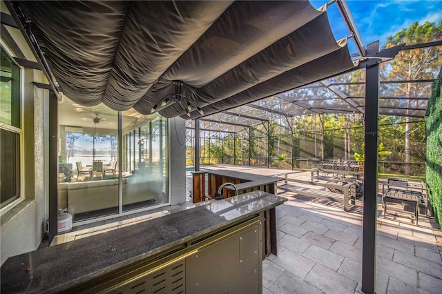 view of patio / terrace with area for grilling, a lanai, and a pergola