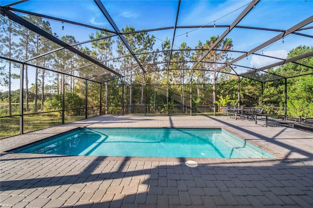 view of swimming pool with a lanai and a patio