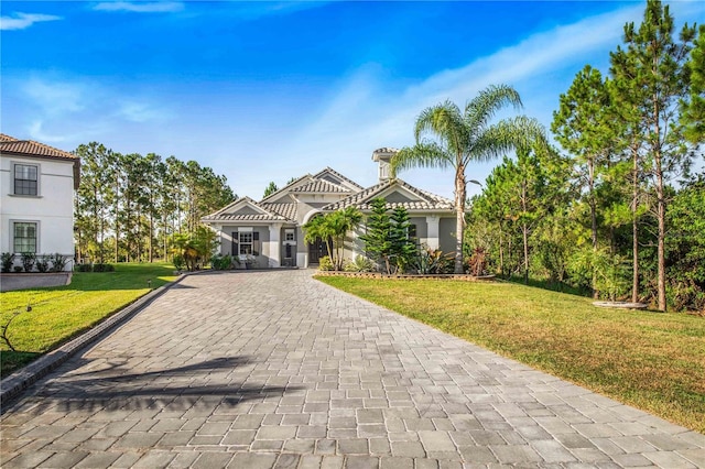 mediterranean / spanish home featuring a front yard