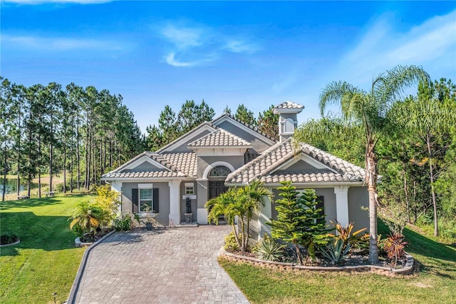 mediterranean / spanish-style house featuring a front lawn