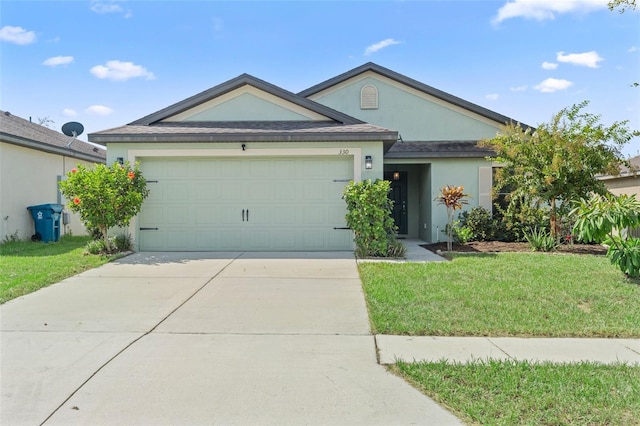 ranch-style house with a garage and a front lawn