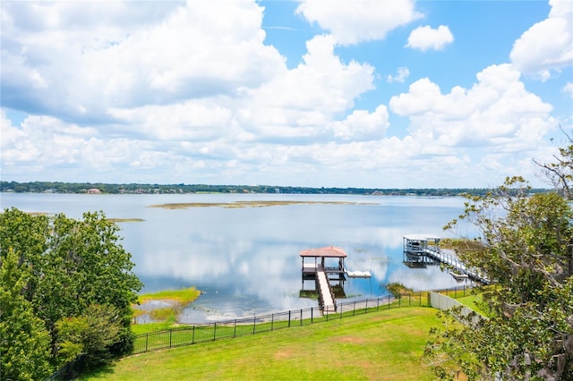 water view featuring a dock and fence