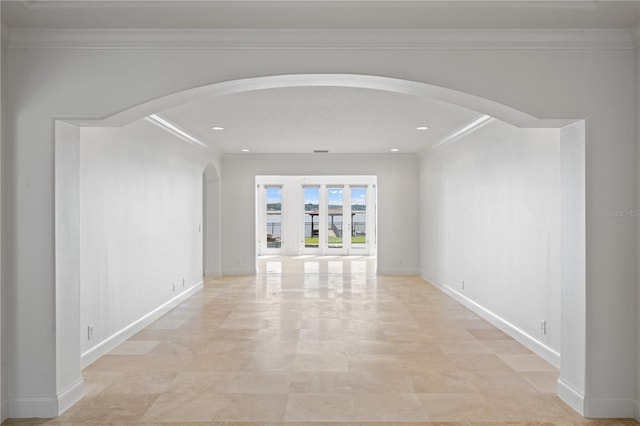 tiled empty room featuring crown molding