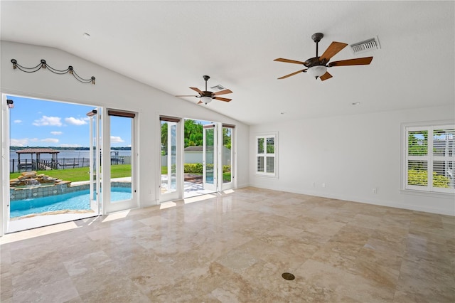 unfurnished room with vaulted ceiling, a healthy amount of sunlight, and ceiling fan