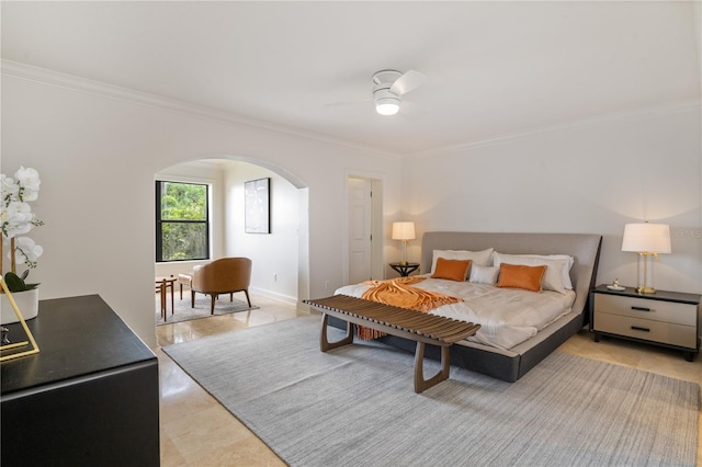 bedroom featuring arched walkways, baseboards, a ceiling fan, and crown molding