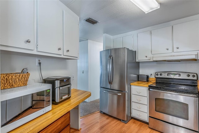 236 Peppertree Ct, Lake Mary, FL 32746 - kitchen with stainless steel appliances, under cabinet range hood, white cabinets, light wood finished floors, and wood counters