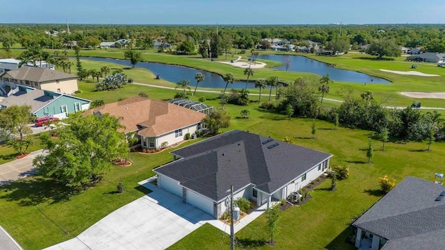 drone / aerial view with a water view and golf course view