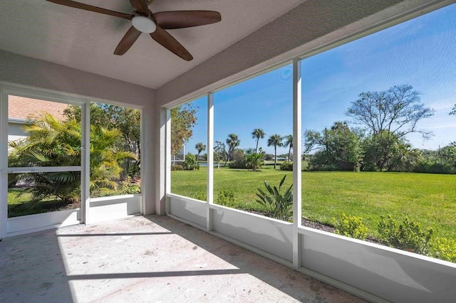 unfurnished sunroom featuring ceiling fan