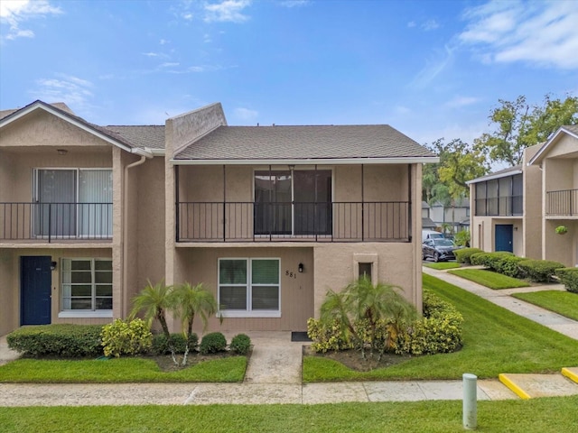 view of front of home with a front lawn and stucco siding