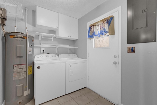 clothes washing area with washer and clothes dryer, light tile patterned floors, cabinet space, electric water heater, and electric panel