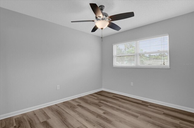 unfurnished room featuring ceiling fan and wood-type flooring