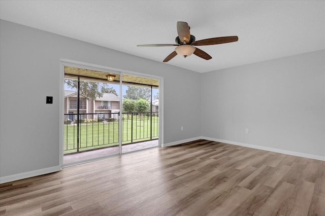 unfurnished room featuring ceiling fan, baseboards, and wood finished floors