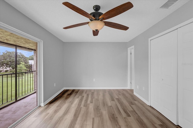 unfurnished bedroom with access to exterior, baseboards, visible vents, and light wood-style floors