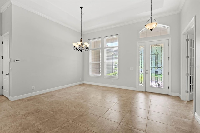 tiled entryway featuring an inviting chandelier and ornamental molding