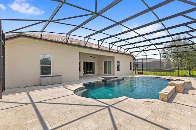 view of swimming pool featuring a patio area, ceiling fan, an in ground hot tub, and glass enclosure