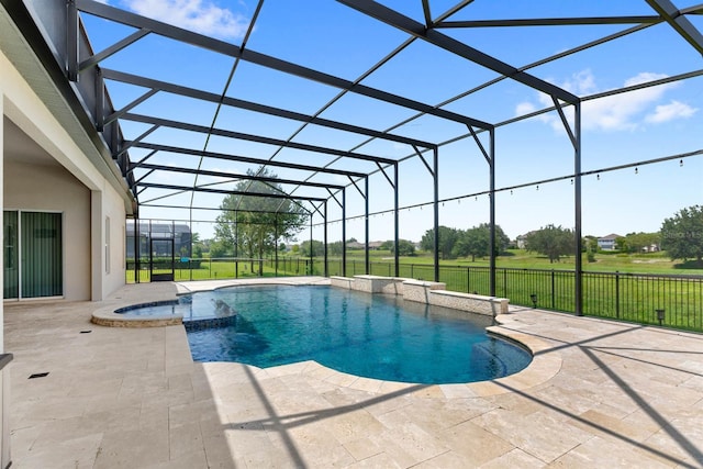 view of pool featuring a patio, glass enclosure, and an in ground hot tub