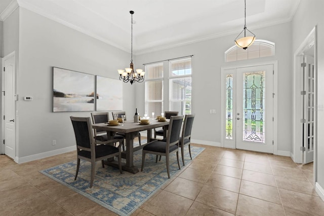 tiled dining space featuring crown molding and a chandelier