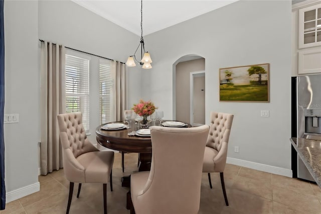 tiled dining space with an inviting chandelier