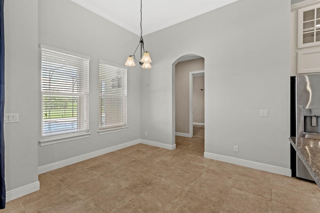 tiled spare room featuring an inviting chandelier