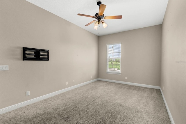 empty room with ceiling fan and carpet floors