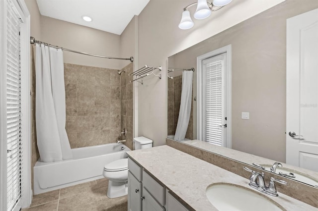 full bathroom featuring shower / tub combo with curtain, toilet, tile patterned floors, vanity, and plenty of natural light