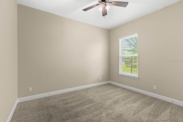 carpeted spare room with ceiling fan