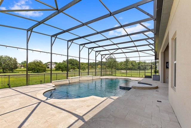 view of swimming pool with a lanai, a patio, a yard, and an in ground hot tub