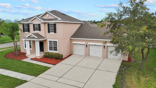 view of property featuring a garage and a front yard