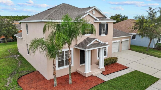 view of front of house with a garage and a front yard