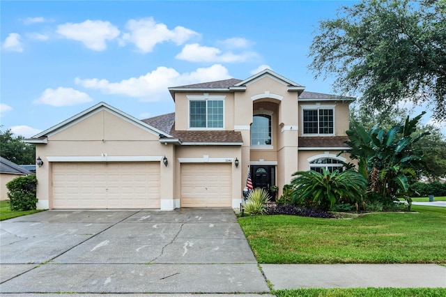 view of front of home featuring a garage and a front yard