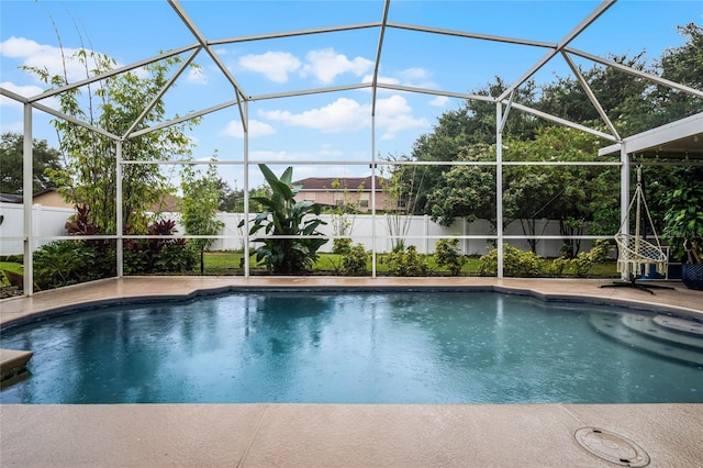 view of pool with glass enclosure