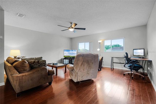 living room featuring a textured ceiling, ceiling fan, and hardwood / wood-style flooring