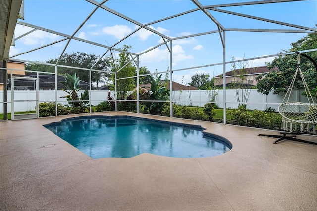 view of swimming pool featuring a patio area and a lanai