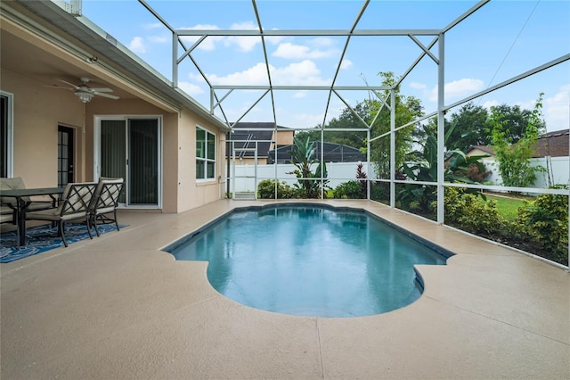 view of swimming pool featuring ceiling fan, a lanai, and a patio area