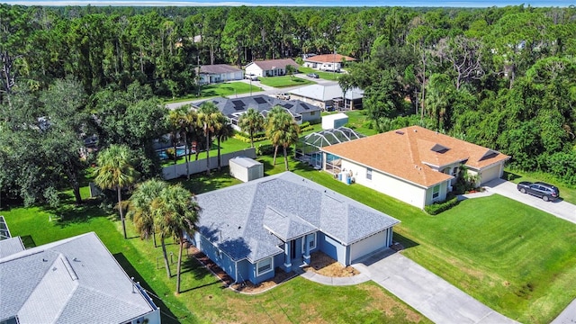 bird's eye view featuring a residential view and a wooded view