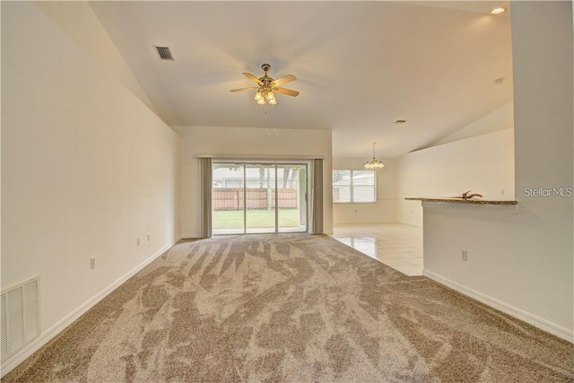 unfurnished living room featuring carpet floors, visible vents, and lofted ceiling