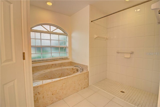 full bath featuring tile patterned flooring, tiled shower, and a bath