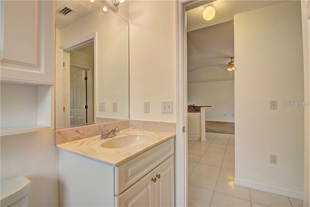 half bathroom featuring visible vents, a ceiling fan, toilet, tile patterned floors, and vanity